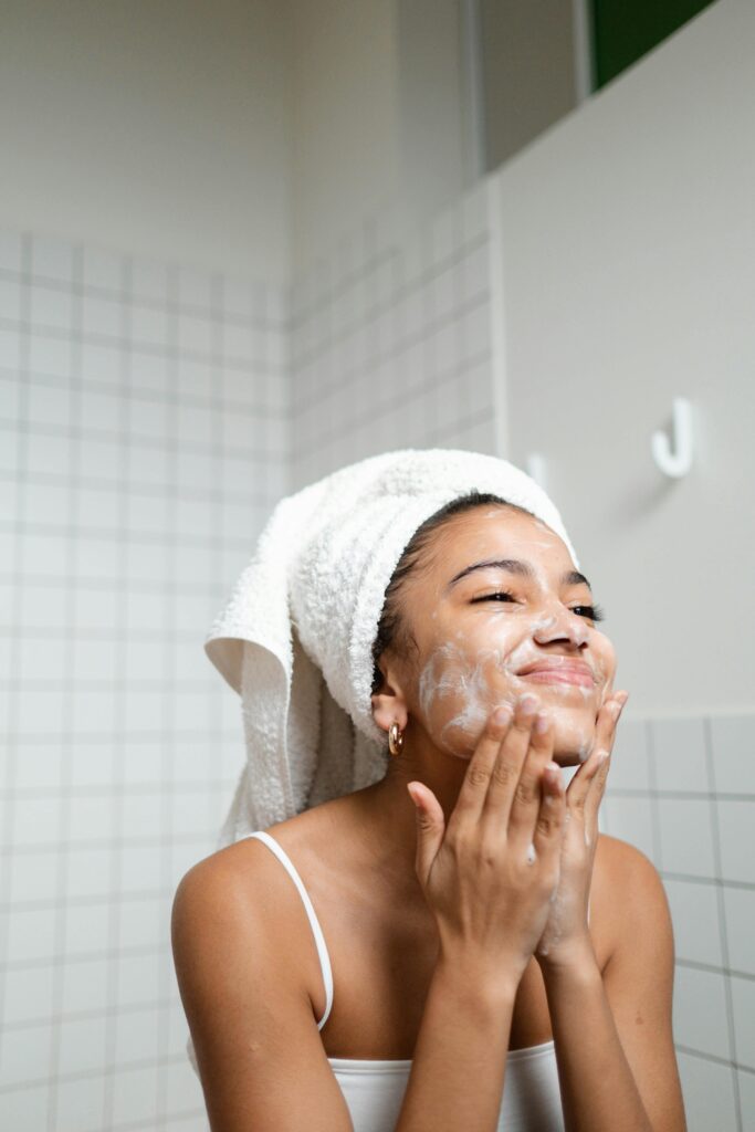 female cleansing face as part of morning skincare routine